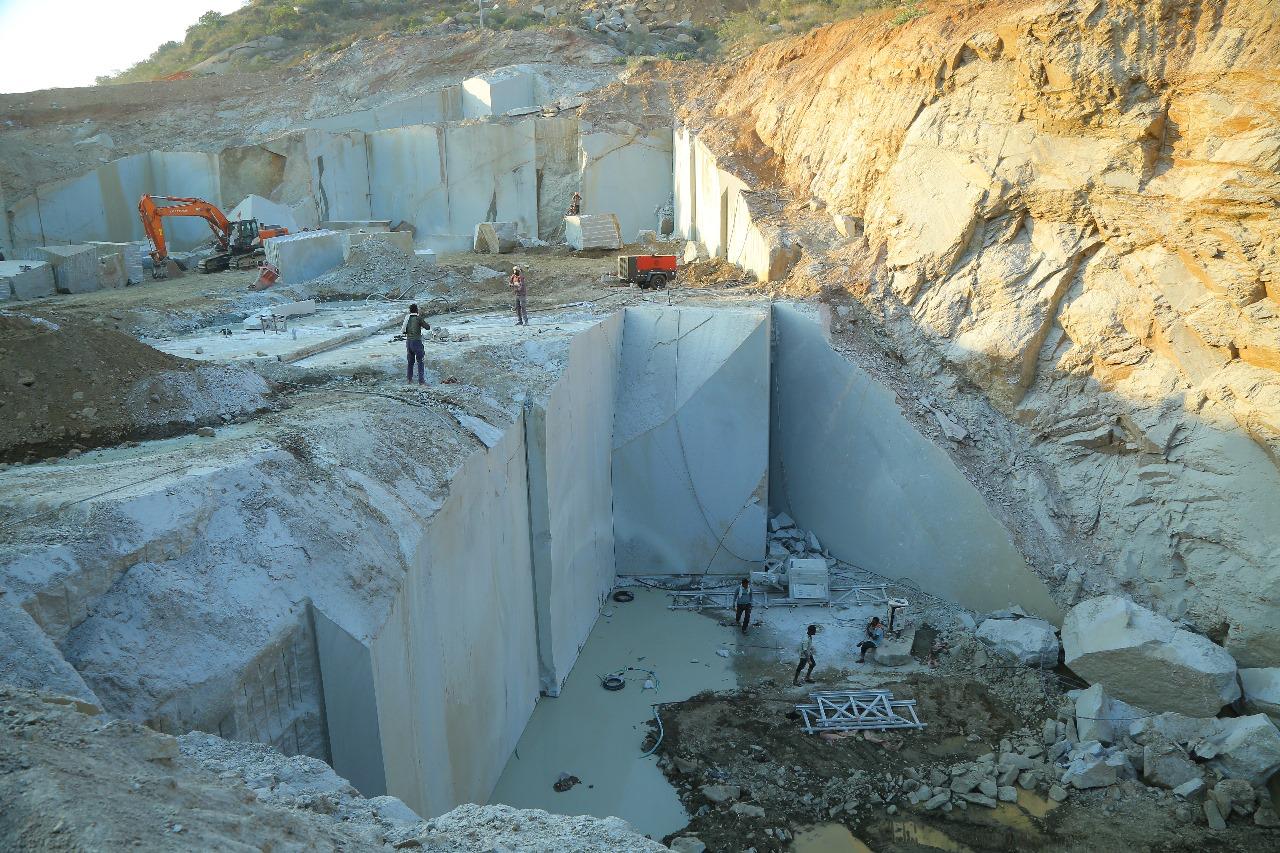 Cutting granite blocks free at the quarry face.